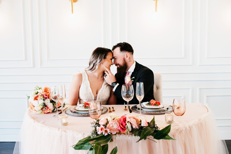 wedding photography, couple at reception table smiling at each other
