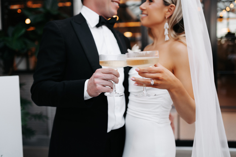 wedding photography, bride and groom holding champagne glasses